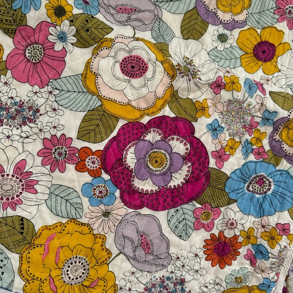 Cynthia Rowley quilted pillow sham with a multicolored boho floral pattern.